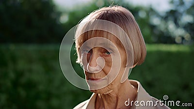Senior woman turning head to camera. Portrait of mature woman posing at camera Stock Photo