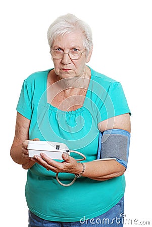 Senior woman unhappy using automatic blood pressur Stock Photo