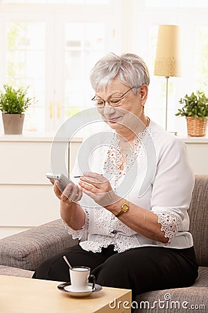 Senior woman using palmtop Stock Photo