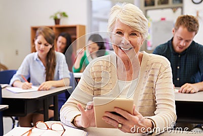 Senior woman using tablet computer at adult education class Stock Photo