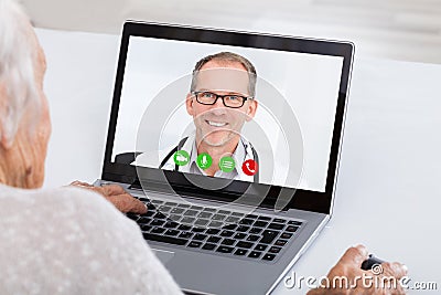 Senior Woman Video Conferencing On Laptop Stock Photo