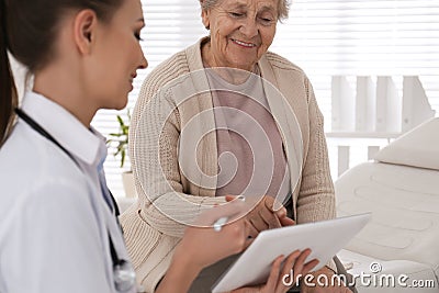 Senior woman visiting doctor in office Stock Photo