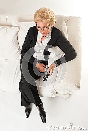 Senior woman watching TV Stock Photo