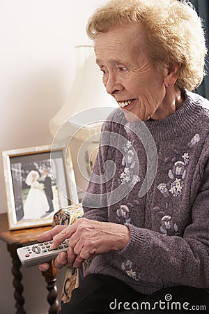 Senior Woman Watching TV At Home Stock Photo