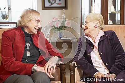 Senior women relaxing in armchairs Stock Photo