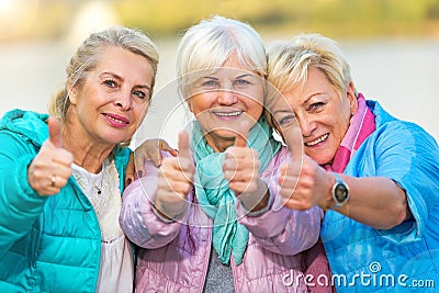 Senior women showing thumbs up Stock Photo