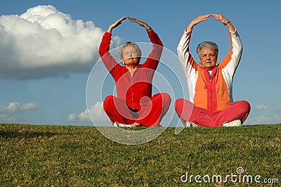 Senior women yoga outdoors Stock Photo