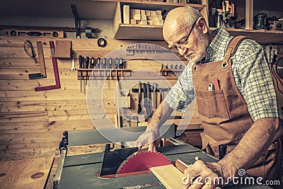 Senior woodworker with tablesaw Stock Photo