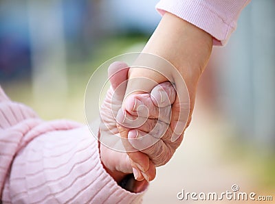 Senior and young holding hands Stock Photo