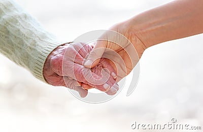 Senior and young holding hands Stock Photo