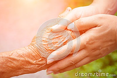 Senior and young holding hands Stock Photo