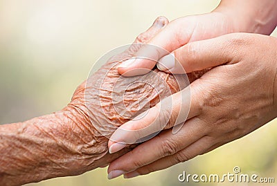 Senior and young holding hands Stock Photo