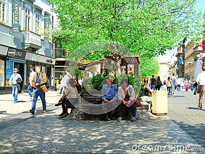 Seniors on a bench in town Editorial Stock Photo