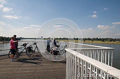 Seniors on a bike - view of the Rhinew Editorial Stock Photo