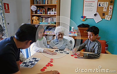 Seniors and childs during therapeutical activities on a nursing home in Mallorca Editorial Stock Photo