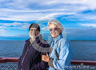 Seniors enjoying the lake on cruise Stock Photo