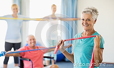 Seniors exercising with stretching bands Stock Photo