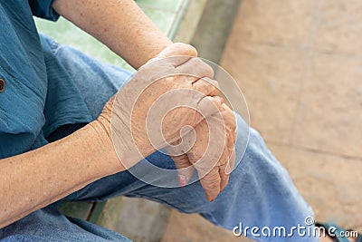 Seniors hands with feeling pain for her hands and arms which might be the elderly diseases such as guillain-barre syndrome and Stock Photo