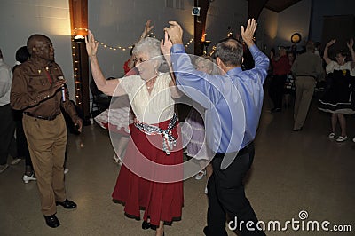 Seniors haviing fun dancing at a square Dance Editorial Stock Photo