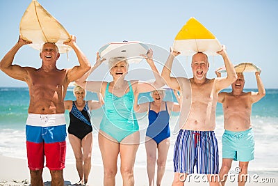 Seniors holding surfboards at the beach Stock Photo
