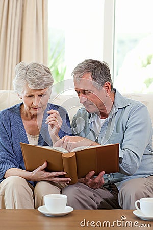 Seniors looking at their photo album Stock Photo