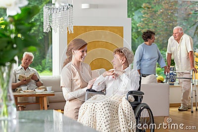 Seniors in a luxury living room of a private retirement home. Te Stock Photo