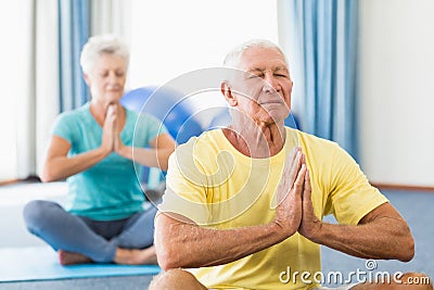 Seniors performing yoga Stock Photo