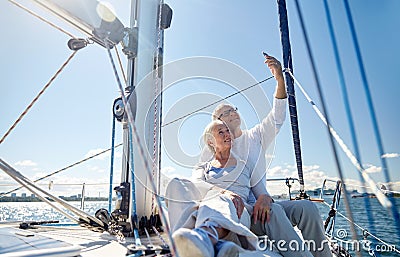 Seniors with smartphone taking selfie on yacht Stock Photo