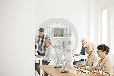 Seniors working on computers Stock Photo