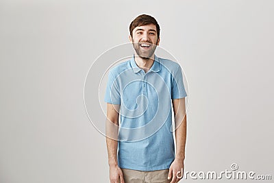 Sense of humour makes man unique. Portrait of slender ordinary caucasian guy with beard and moustache laughing and Stock Photo