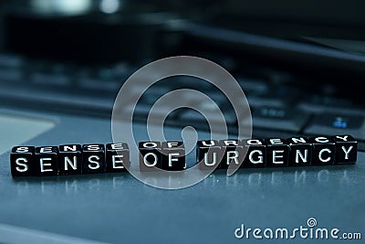Sense of urgency text wooden blocks in laptop background. Business and technology concept Stock Photo