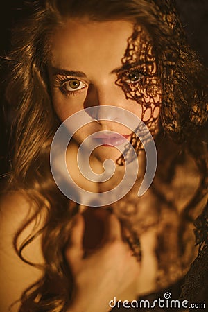 Sensitive sexy portrait of a girl with a lacy shadow on her face. Feminine and sexy. Mysterious atmospheric twilight Stock Photo