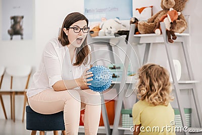 A sensory game with a blue ball played by a professional child t Stock Photo