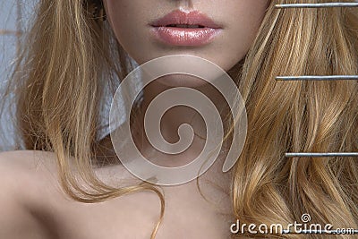 A sensual blonde woman peers out from under the br Stock Photo