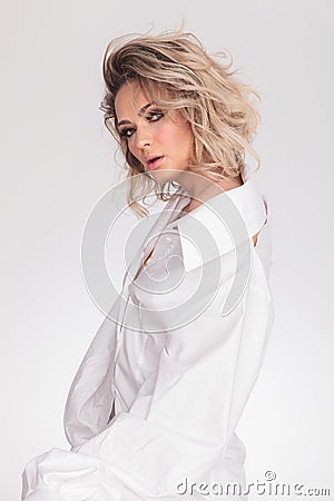 Sensual blonde woman wearing a bouffant white shirt Stock Photo