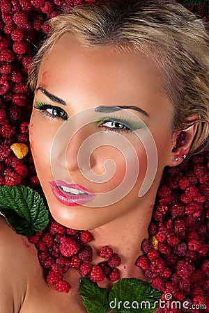Sensual female face in raspberries Stock Photo