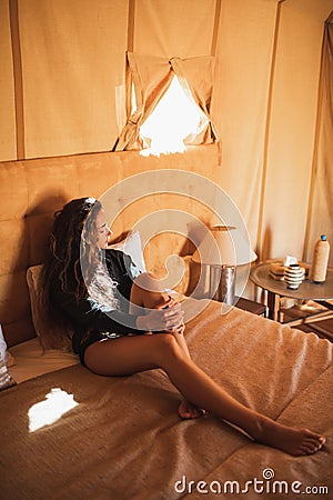 Sensual glamour portrait woman in interior of modern luxury glamping tent camp Stock Photo