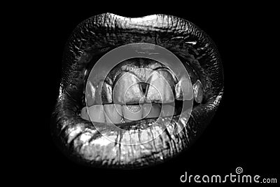 Sensual golden woman lips. Aggressive angry mouth. Womans gold lip. Female mouth close up. Stock Photo