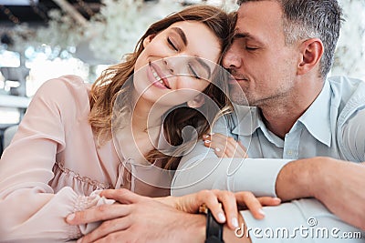 Sensual lovely couple sitting togther with closed eyes Stock Photo