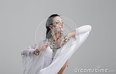 Sensual oriental belly dancer performance portrait on gray Stock Photo
