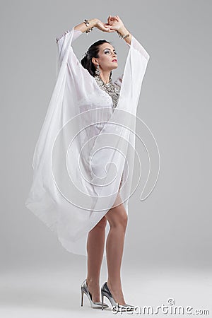 Sensual oriental brunette belly dancer in high heels performance Stock Photo