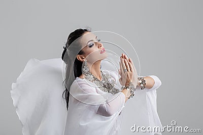 Sensual oriental belly dancer performance pray on grey Stock Photo