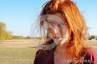 Sensual sexy portrait of young beautiful mischievous smiling redhead girl, outdoors in the summer sunlight Stock Photo