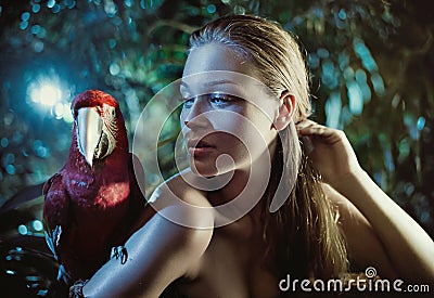 Sensual woman with a colorful parrot Stock Photo