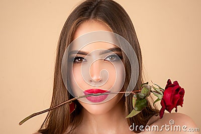 Sensual woman with red lips with red rose, beige background. Stock Photo