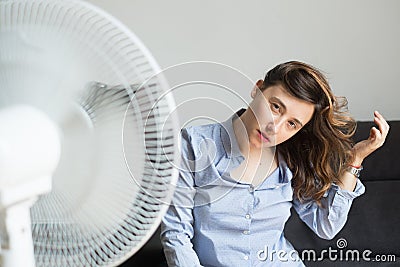 Sensual woman refreshing in front of cooling fan Stock Photo
