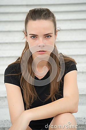 Sensual woman relax on steps in paris, france. Woman with long hair on staircase. Girl with young look and beauty. Fashion model w Stock Photo