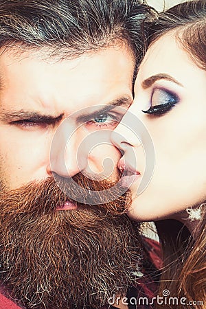 Sensual woman kiss bearded man, love. Woman with makeup skin and hipster with long beard. Couple in love and family Stock Photo