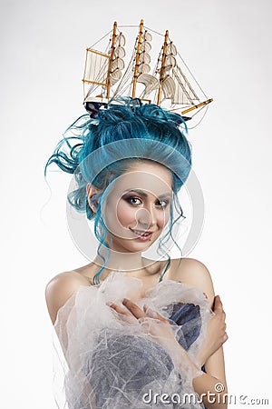 Sensual young girl with naked shoulders and painted blue hair st Stock Photo