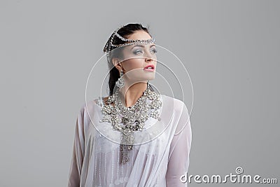 Sensual young oriental princess portrait on gray Stock Photo